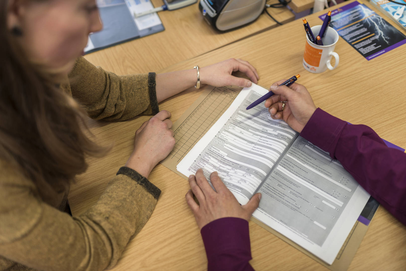 Two people are looking over a BAföG application