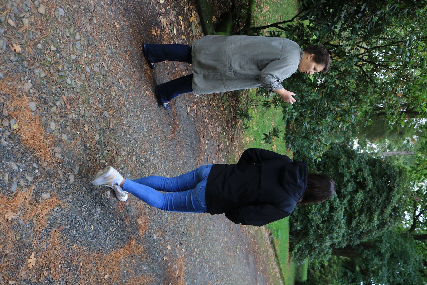 A consultant and a client are walking side by side outdoors and chatting