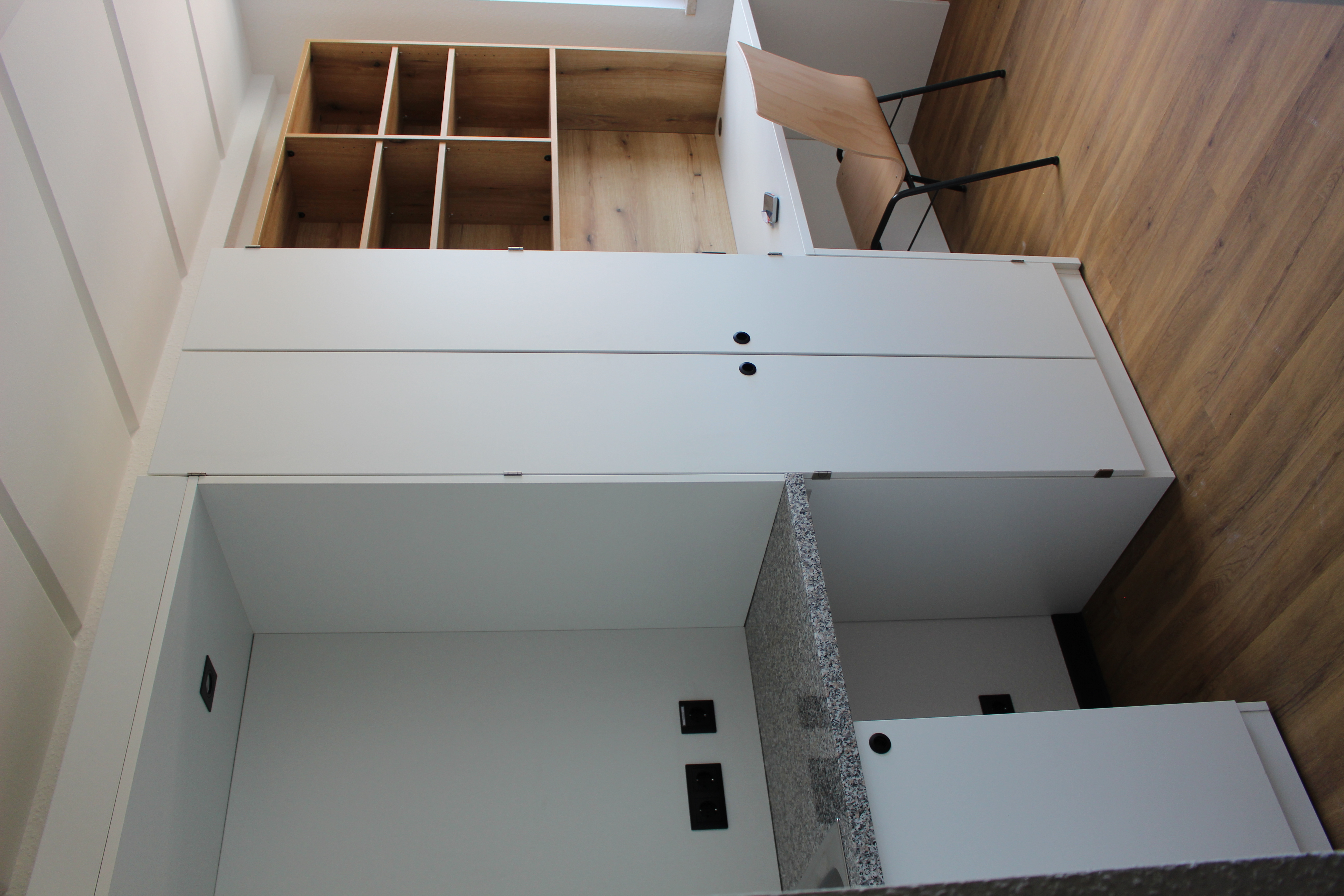 small kitchenette, cupboard and workspace with shelving and a desk